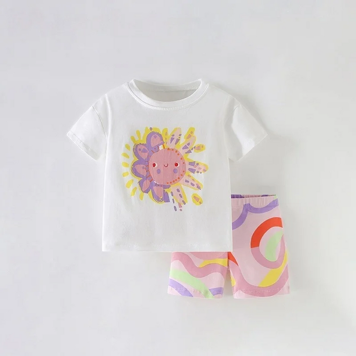 White sunshine-graphic T-shirt paired with pastel swirl shorts
