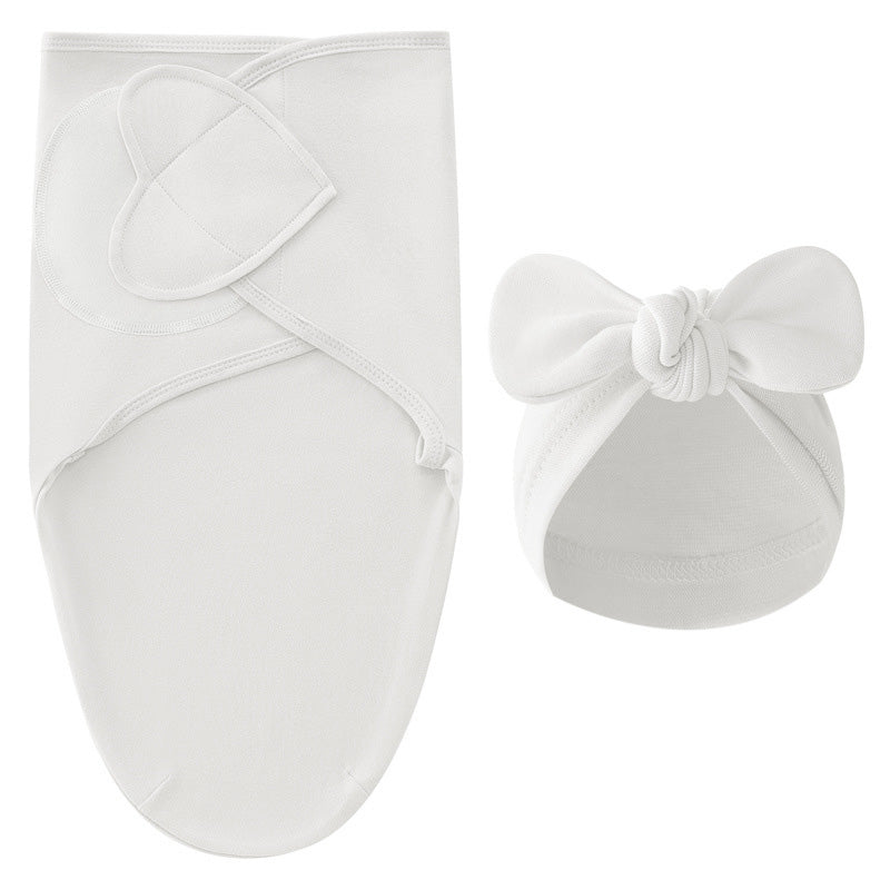 White swaddle blanket and matching white bow hat