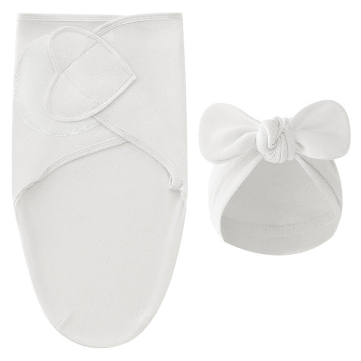 White swaddle blanket and matching white bow hat