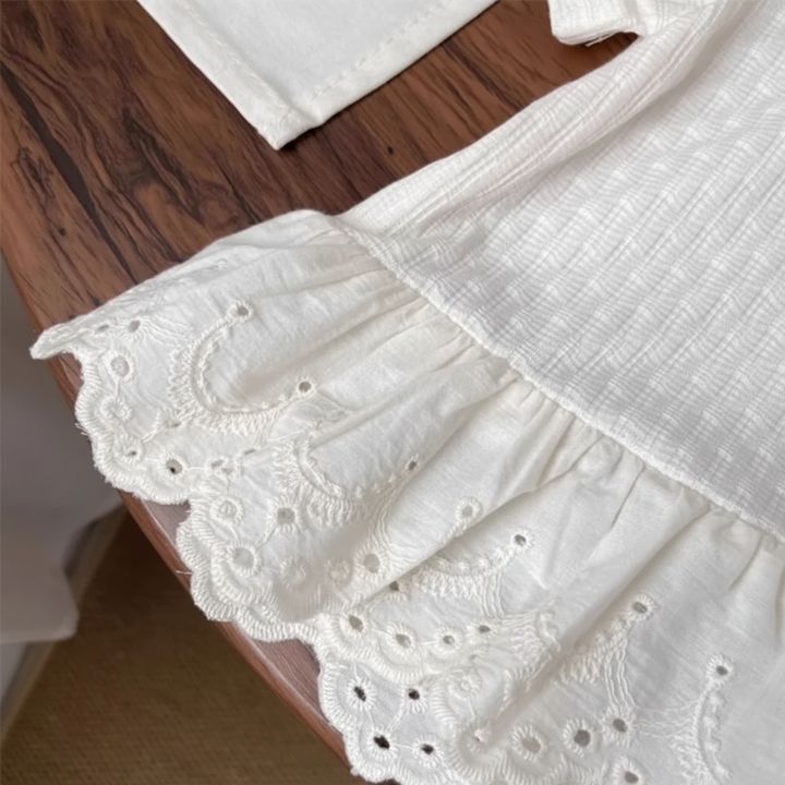 White T-shirt hem with gathered embroidered lace and a scalloped edge.