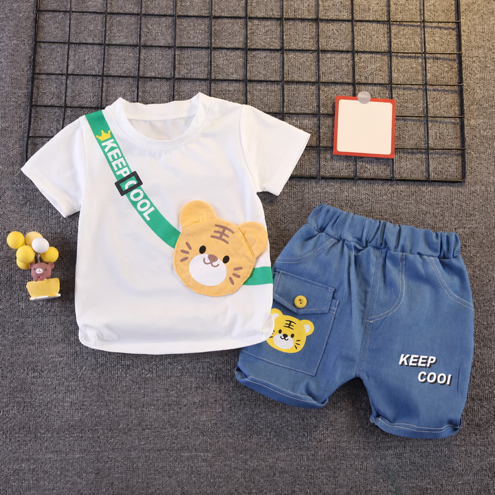 White tiger T-shirt and blue shorts with animal and lettering details laid flat
