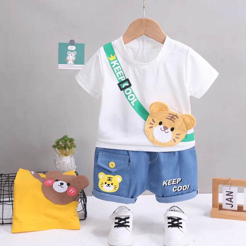 White tiger-graphic T-shirt with blue shorts and a folded yellow T-shirt beside it