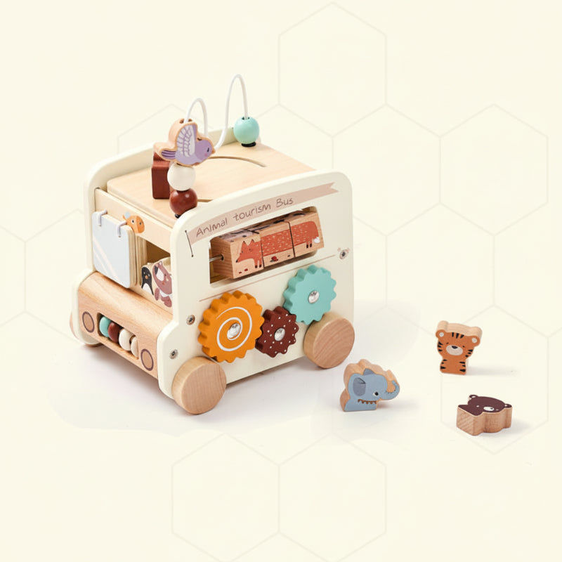White wooden activity bus with colorful gears and three animal-shaped blocks