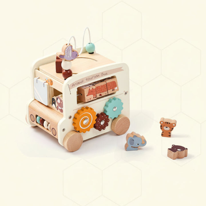 White wooden activity bus with colorful gears and three animal-shaped blocks