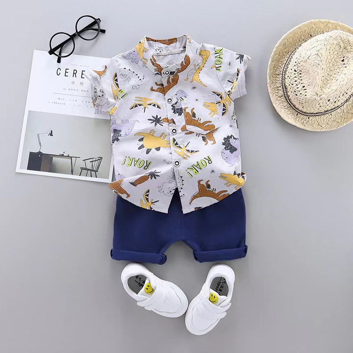 White shirt with yellow and brown dinosaurs paired with navy shorts