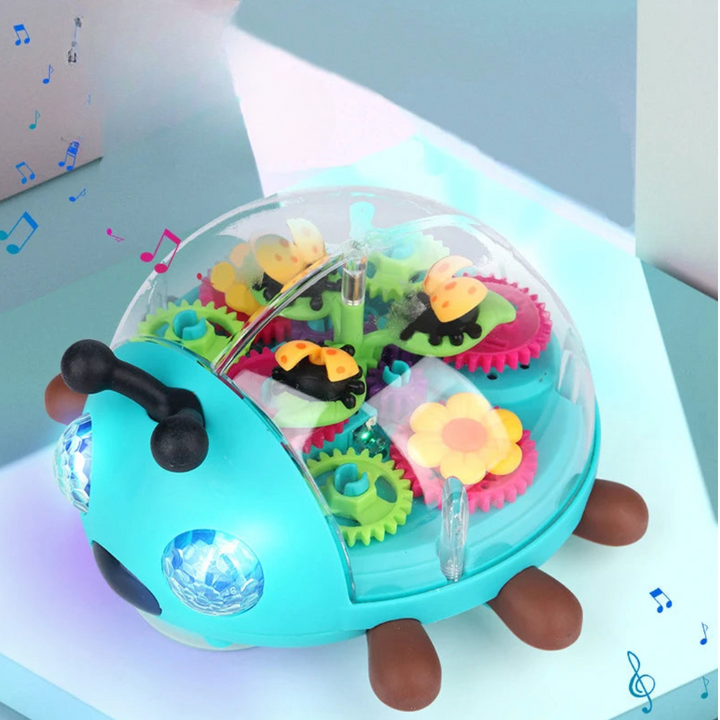 Turquoise musical beetle toy with a clear shell, colorful gears, and illuminated eyes