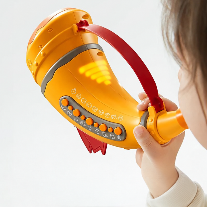 Child holding an orange toy horn with animal buttons and illuminated side bars