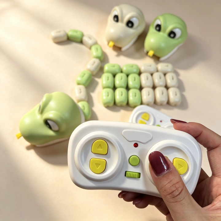 Close-up of the white wireless controller with yellow directional buttons beside snake toy pieces