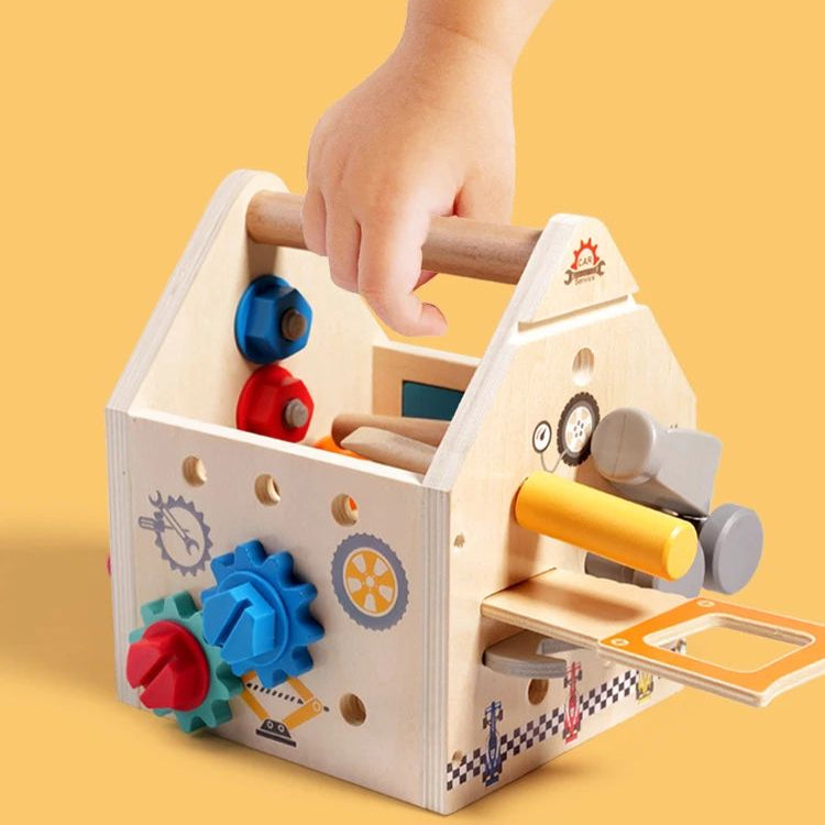 Hand carrying the wooden activity box by its handle with toy tools stored inside