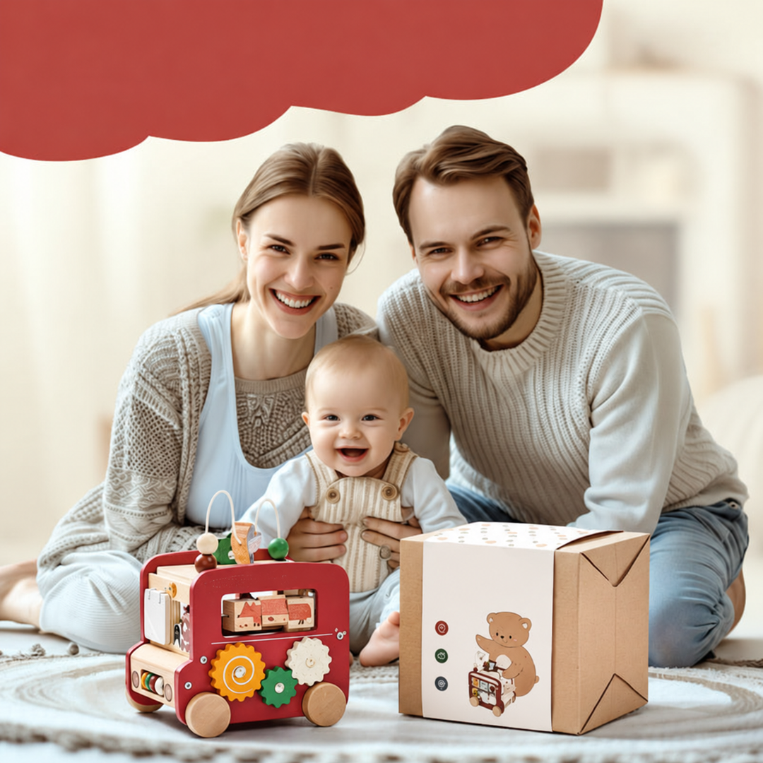 Family sitting with the red wooden activity bus and its illustrated box