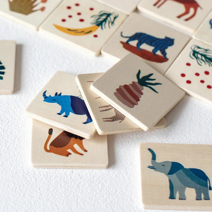Close-up of wooden matching tiles with elephant, rhino, lion, and plant illustrations
