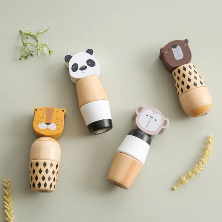Four wooden animal stacking toys arranged flat on a pale green surface