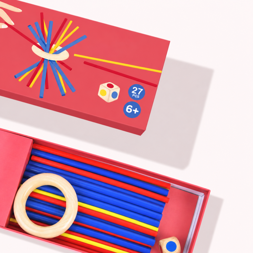 Open and closed game boxes showing colored wooden sticks, a wooden ring, and a die.