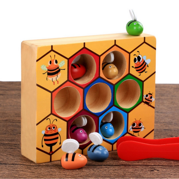 Wooden bee sorting puzzle with colored hive openings, bee pieces, and red tweezers
