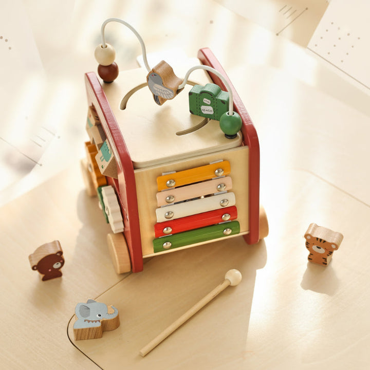 Wooden activity bus with a colorful xylophone, wooden mallet, and animal-shaped blocks
