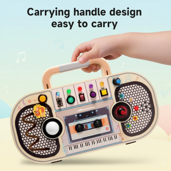 A hand carrying the wooden music busy board by its built-in handle