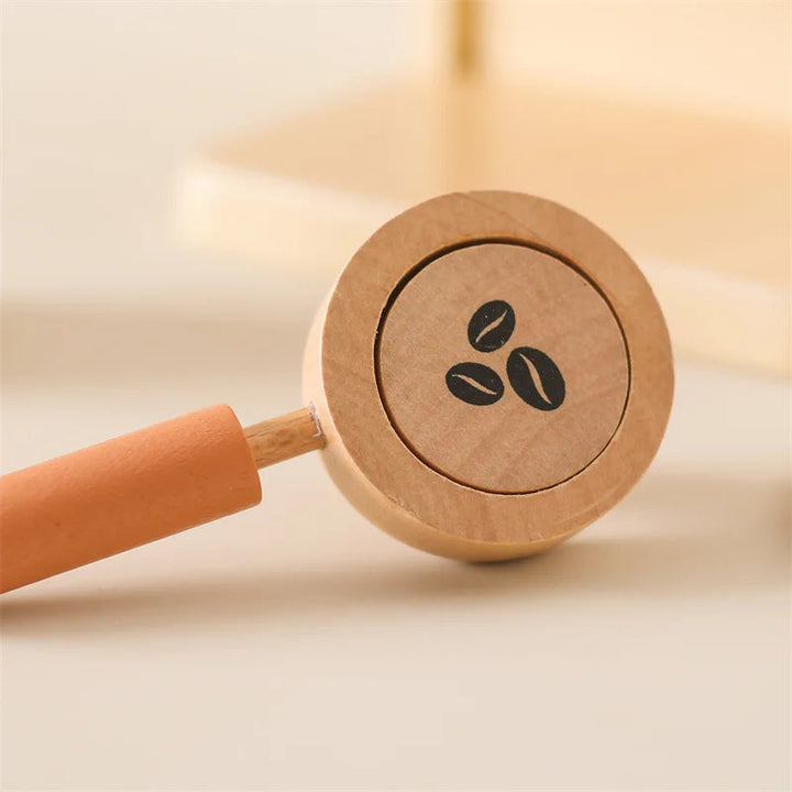 Removable wooden coffee handle holding a disc printed with coffee beans.