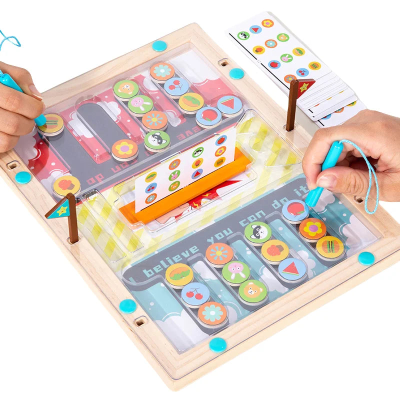 Two magnetic wands guide colored pieces on a wooden game board with a pattern card in the center.