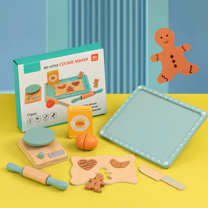 Wooden baking toys with a mint-green tray, rolling pin, scale, cookie shapes and pretend ingredients