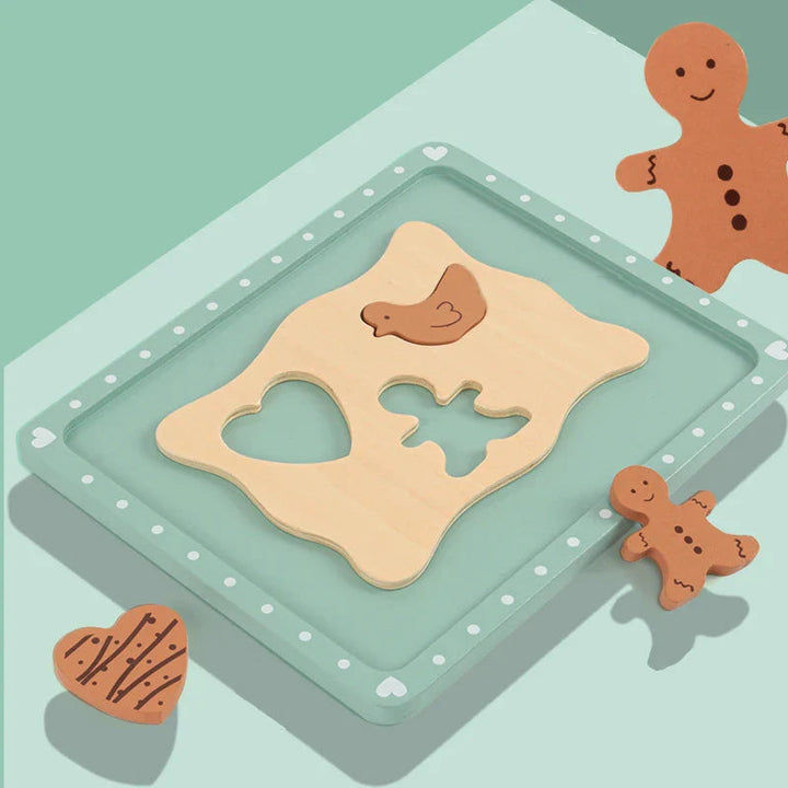 Heart, bird and gingerbread-person cookie shapes with a wooden dough board on a mint-green tray