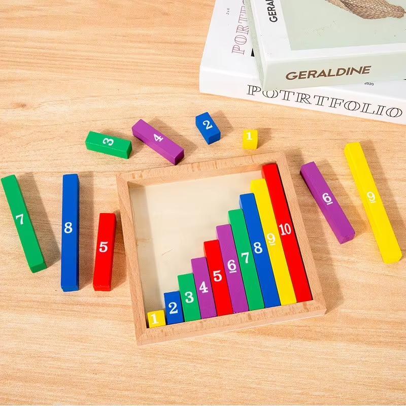 Wooden math board on a table with loose colored number pieces around the tray