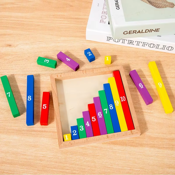 Wooden math board on a table with loose colored number pieces around the tray