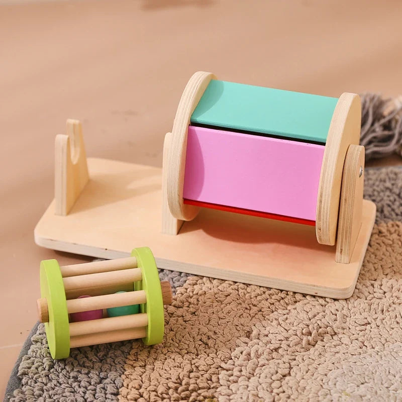Colorful wooden drum on its base with the removable rattle resting in front