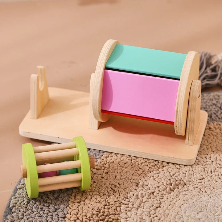 Colorful wooden drum on its base with the removable rattle resting in front