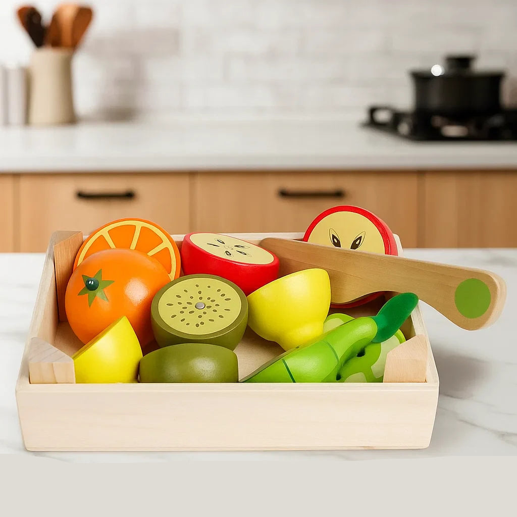 Wooden fruit play food with kiwi, apple, citrus pieces, and a toy knife in a tray