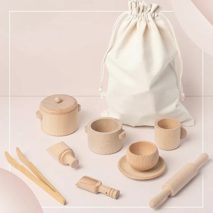 Wooden kitchen play pieces arranged beside a drawstring storage bag.