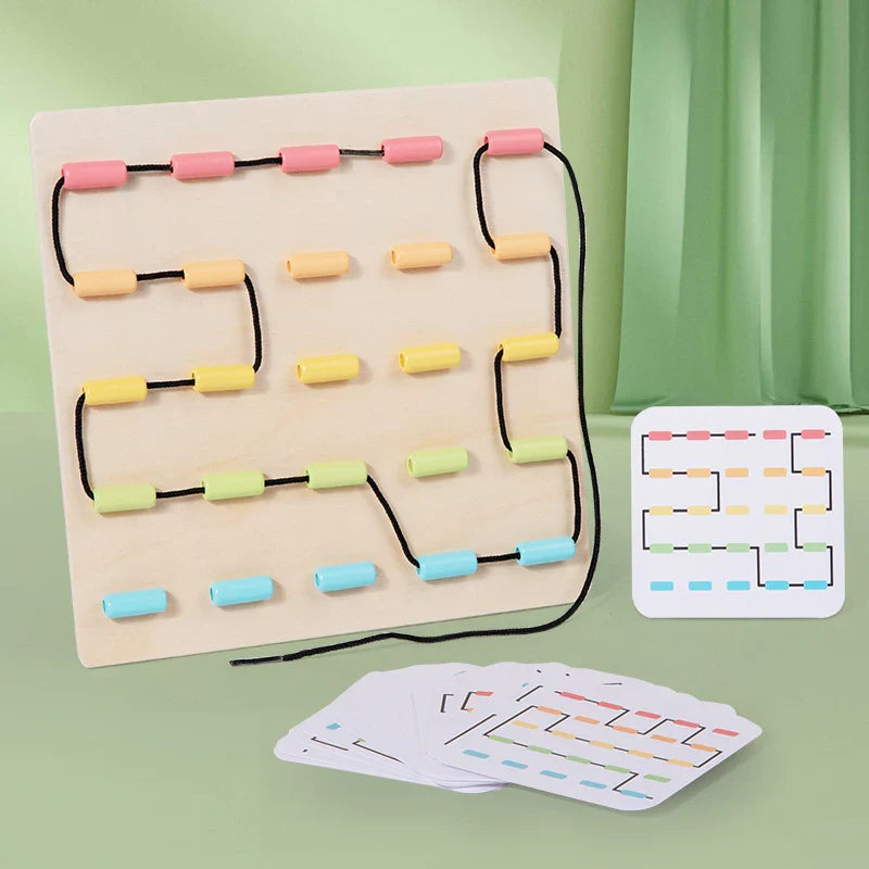 Wooden lacing board with a winding black cord, pastel guides, and illustrated pattern cards.