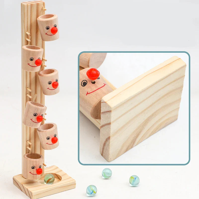 Wooden clown marble tower with a wood-grain detail inset and marbles nearby