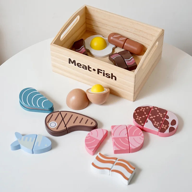 Wooden meat, fish, and egg play food beside a storage crate