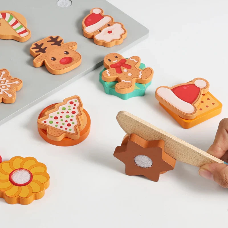 Toy knife separating a flower-shaped wooden cookie beside festive cookie pieces.
