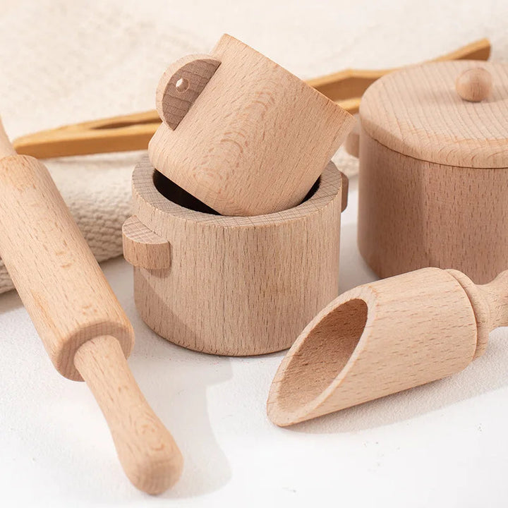 Close-up of wooden cups, a lidded pot, rolling pin and large scoop.
