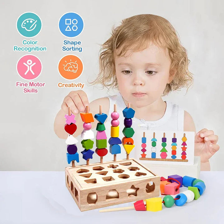 Child stacking wooden shapes while holding a pattern card beside the activity box