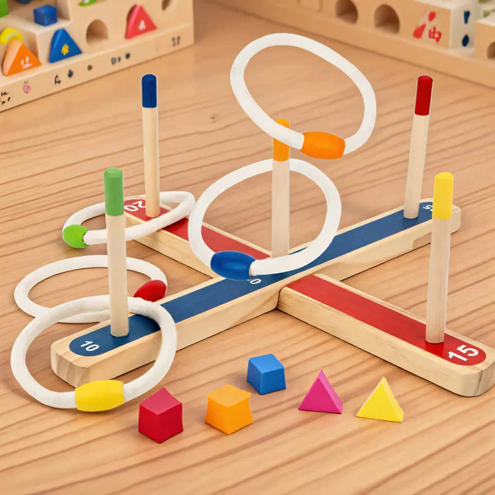 Wooden ring toss game with five color-tipped pegs, white rings, and a numbered cross-shaped base.