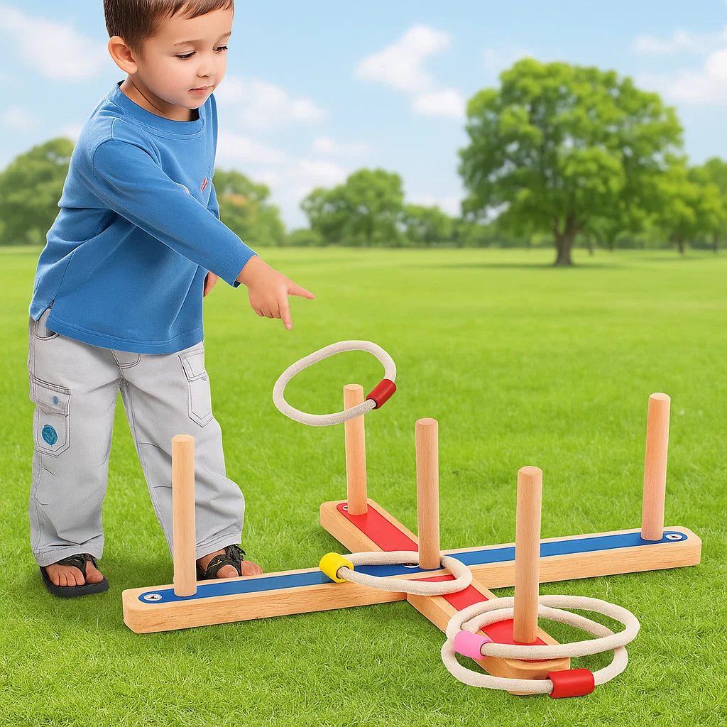 Child tossing a ring toward a wooden ring toss game on the grass.