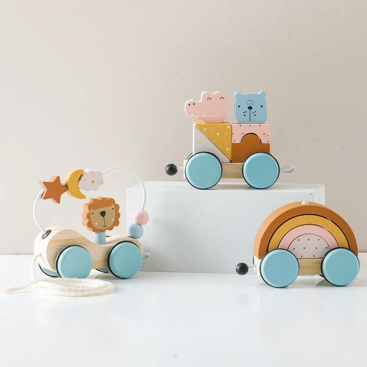 Wooden stacking train with animal blocks, rainbow arches, and light blue wheels displayed on white platforms