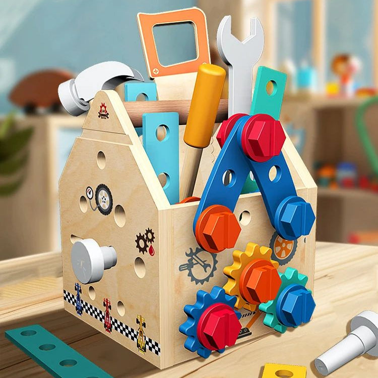 Wooden activity box on a table with toy tools inside and colorful gears and bolts on the side