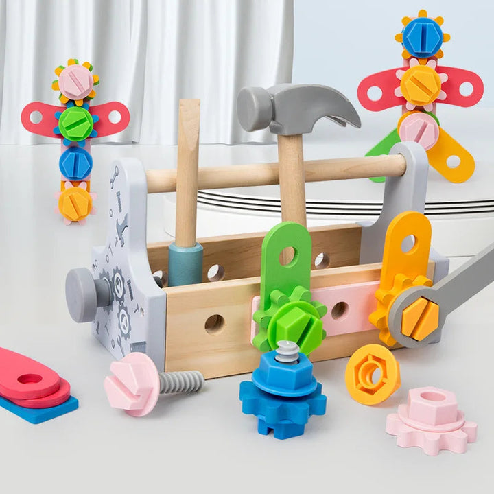 Wooden toolbox with colorful parts assembled along the sides and tools stored upright.