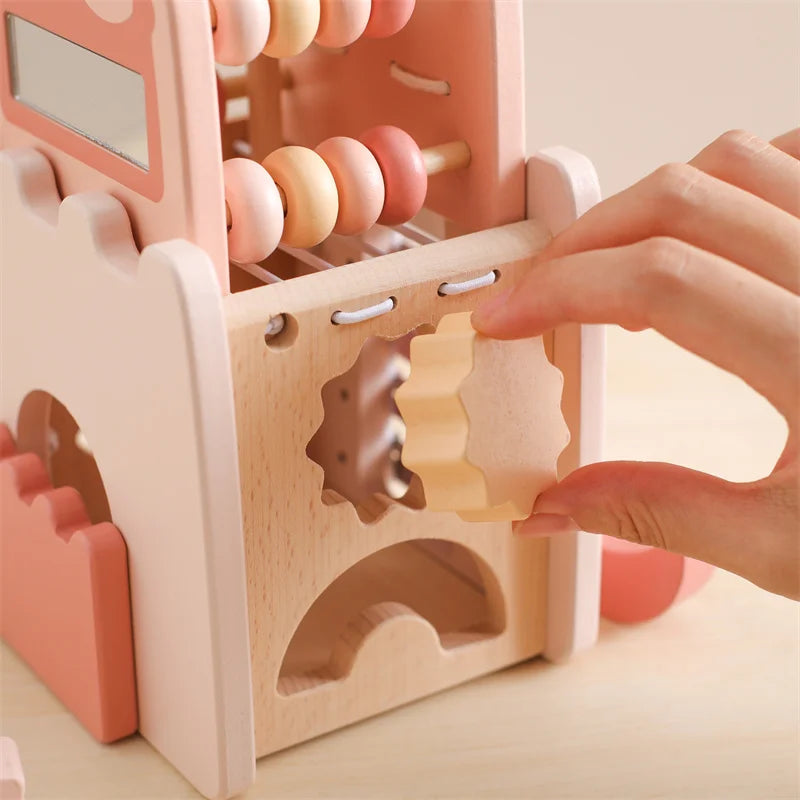 Hand matching a yellow shape to an opening in the wooden castle tower