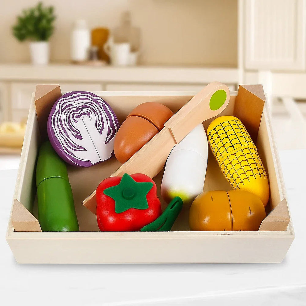 Wooden vegetable play food with cabbage, corn, pepper, and a toy knife in a tray
