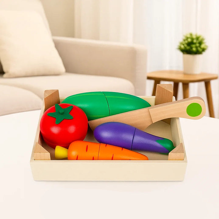 Wooden vegetable play food with tomato, carrot, eggplant, and a toy knife in a tray