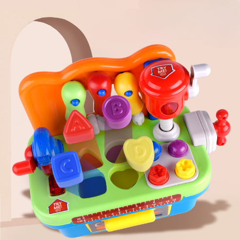 Top view of a toy workbench with lettered shape pieces above matching worktop openings