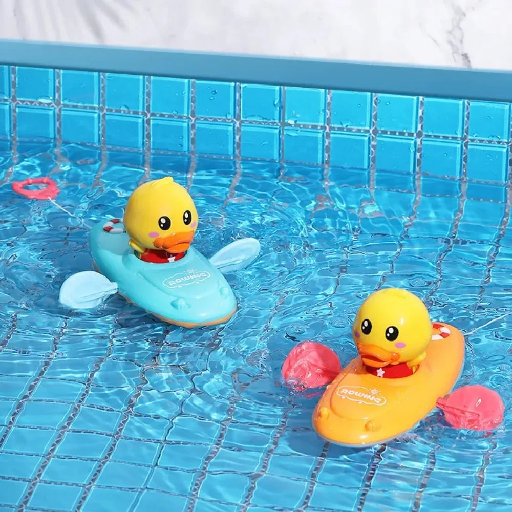 Blue and yellow duck boats with side paddles floating in a tiled pool