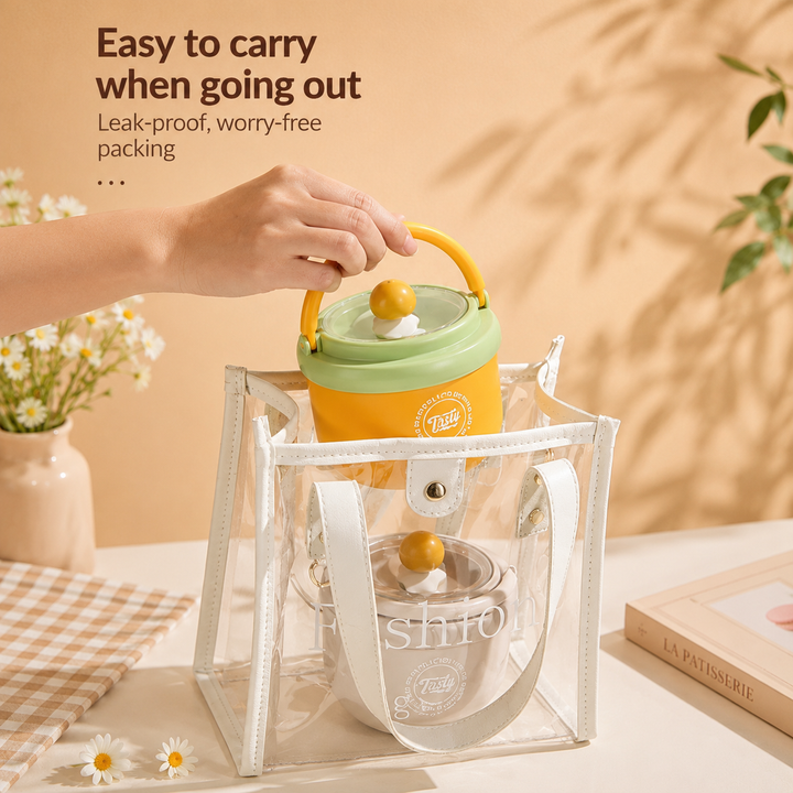 Yellow lunch bowl being lowered into a clear tote beside a gray bowl.