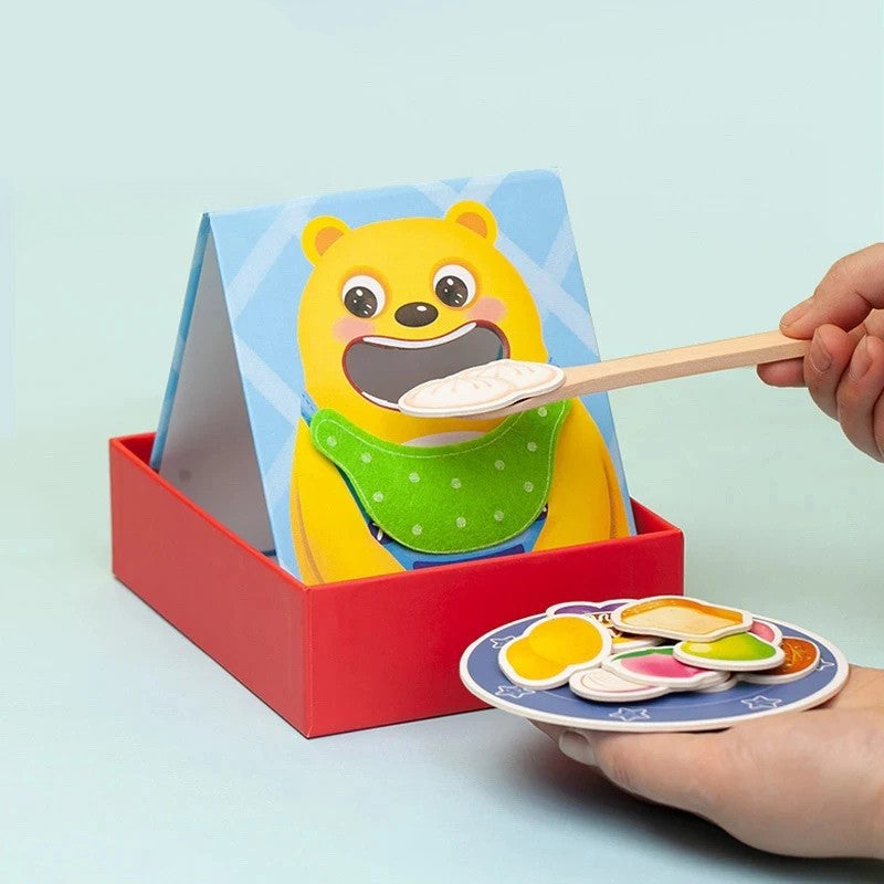Yellow animal feeding board with a spoon, pretend food pieces, and a plate in a red tray
