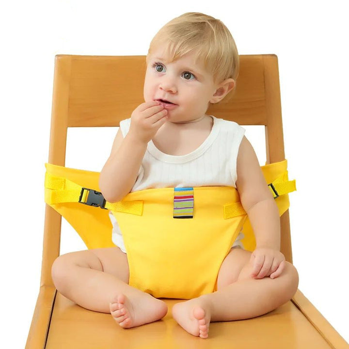 Front view of the yellow baby chair harness with its fabric panel and buckle straps.