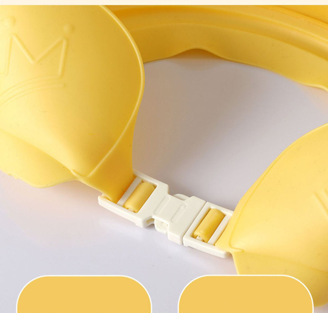 Close-up of the white rear buckle and adjustable band on a yellow bath cap